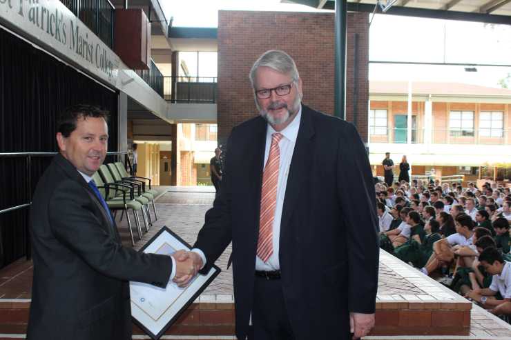 Brenton Gurney receiving his certificate from Greg Whitby.