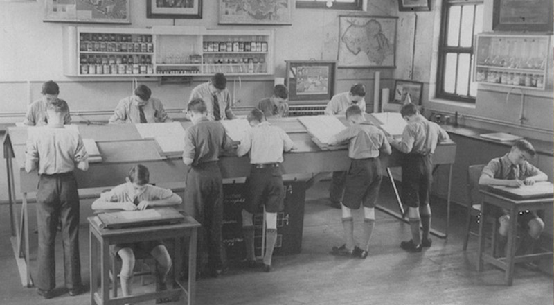 Historical image of St Patrick's Marist College Dundas students standing at desks to learn