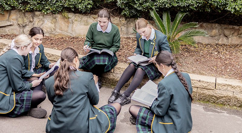 St Patrick's Marist College Dundas students sitting outside learning