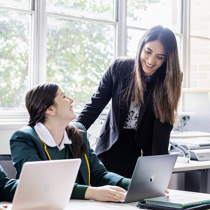 Teacher helping student at St Patrick's Marist College Dundas