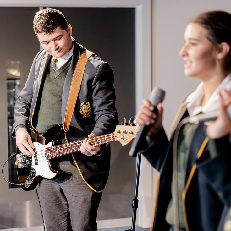 St Patrick's Marist College Dundas students playing guitar and singing